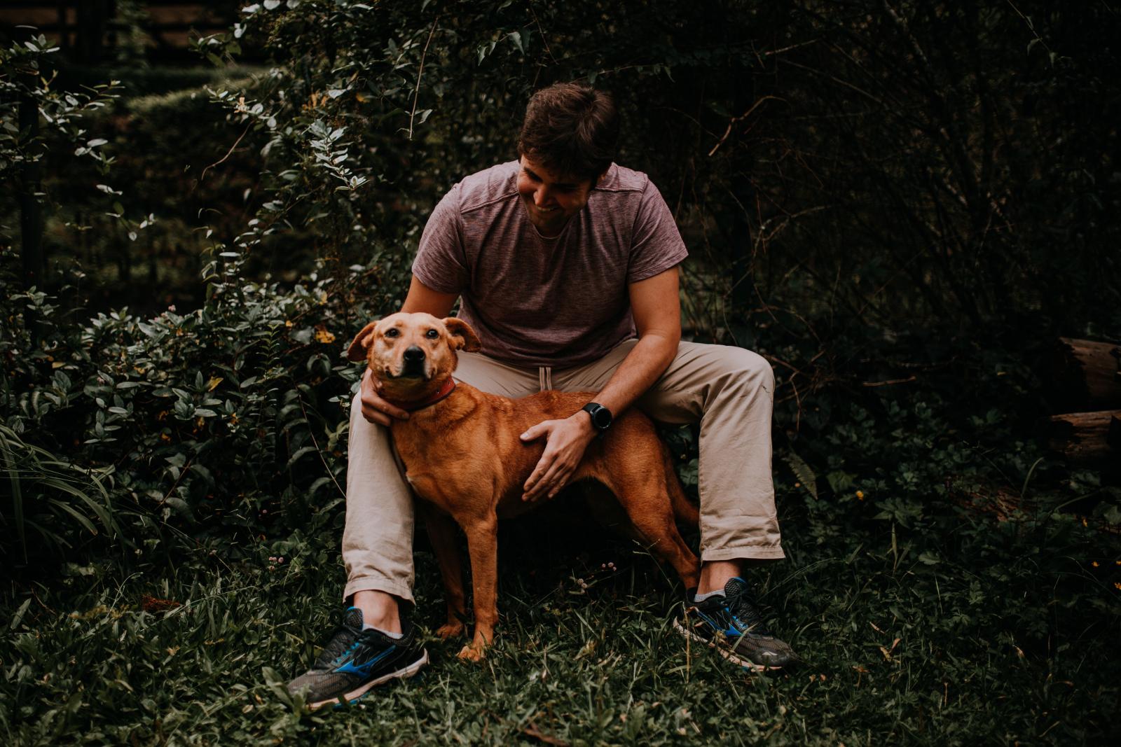 sam with his dog in the woods