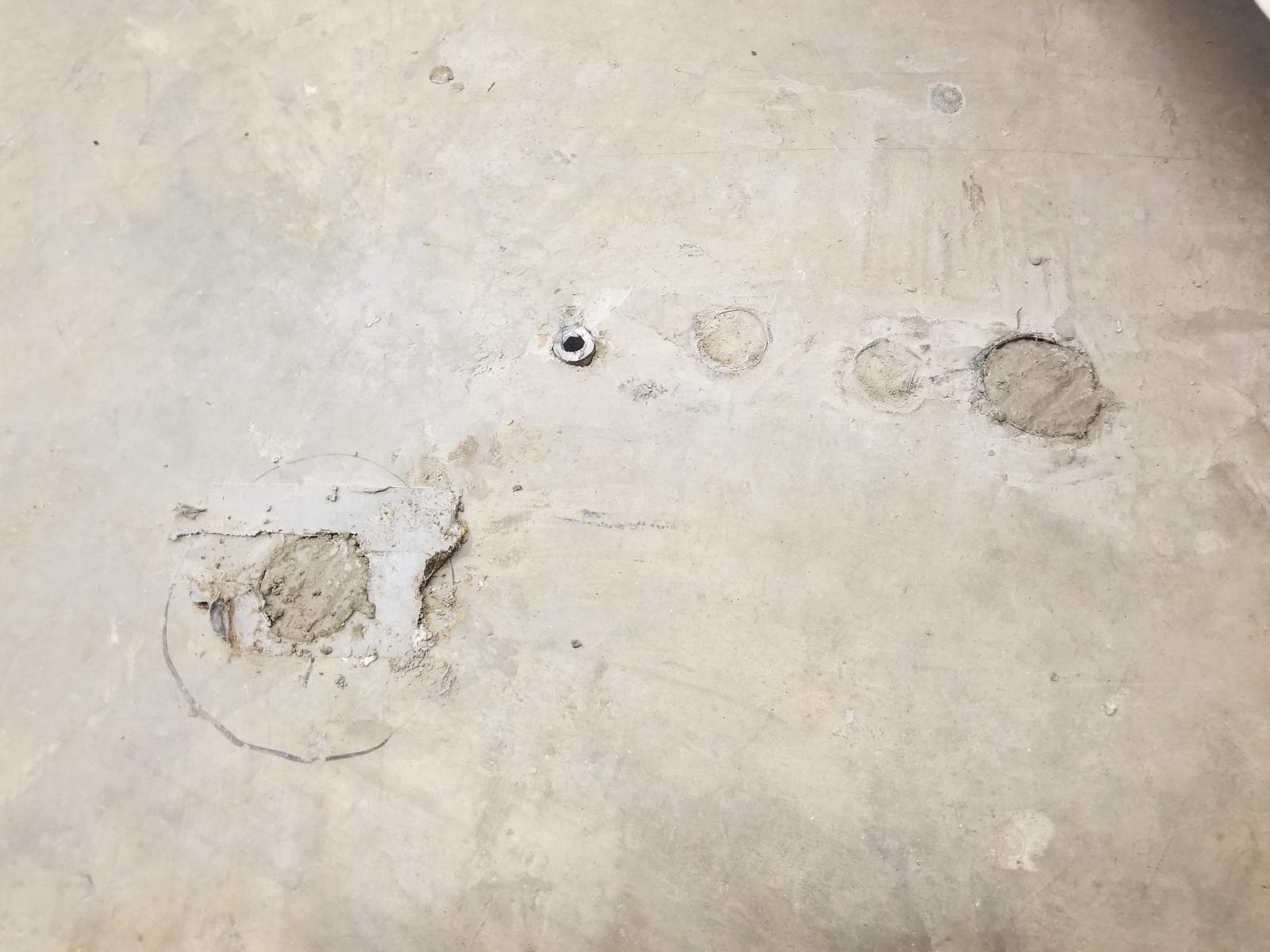 Filling holes in the floor with Quikcrete