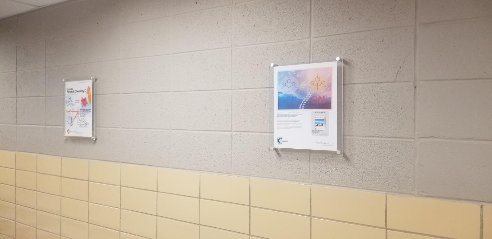 Hung up cover art on the first floor of Hand Lab