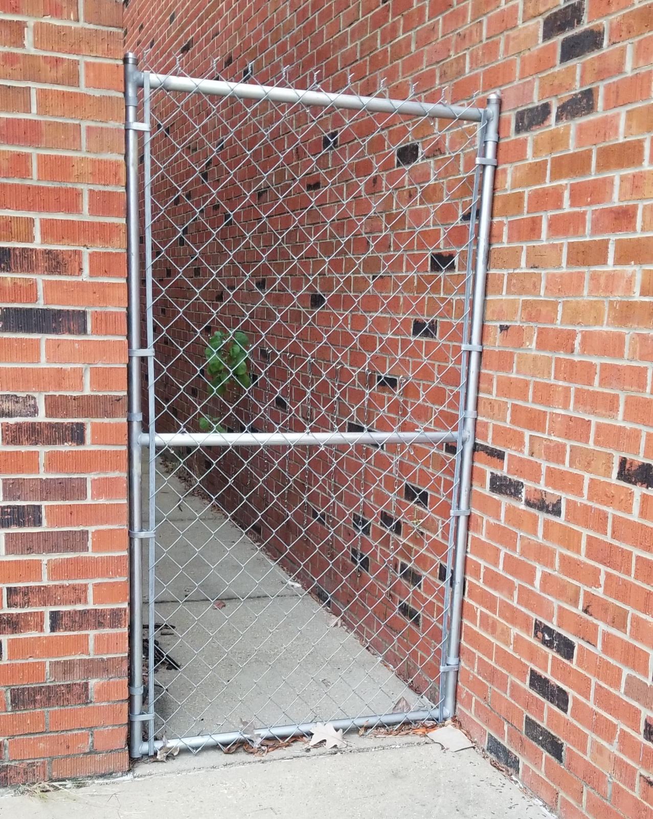 Mounted fence to alleyway outside of Hand Lab (south entrance)