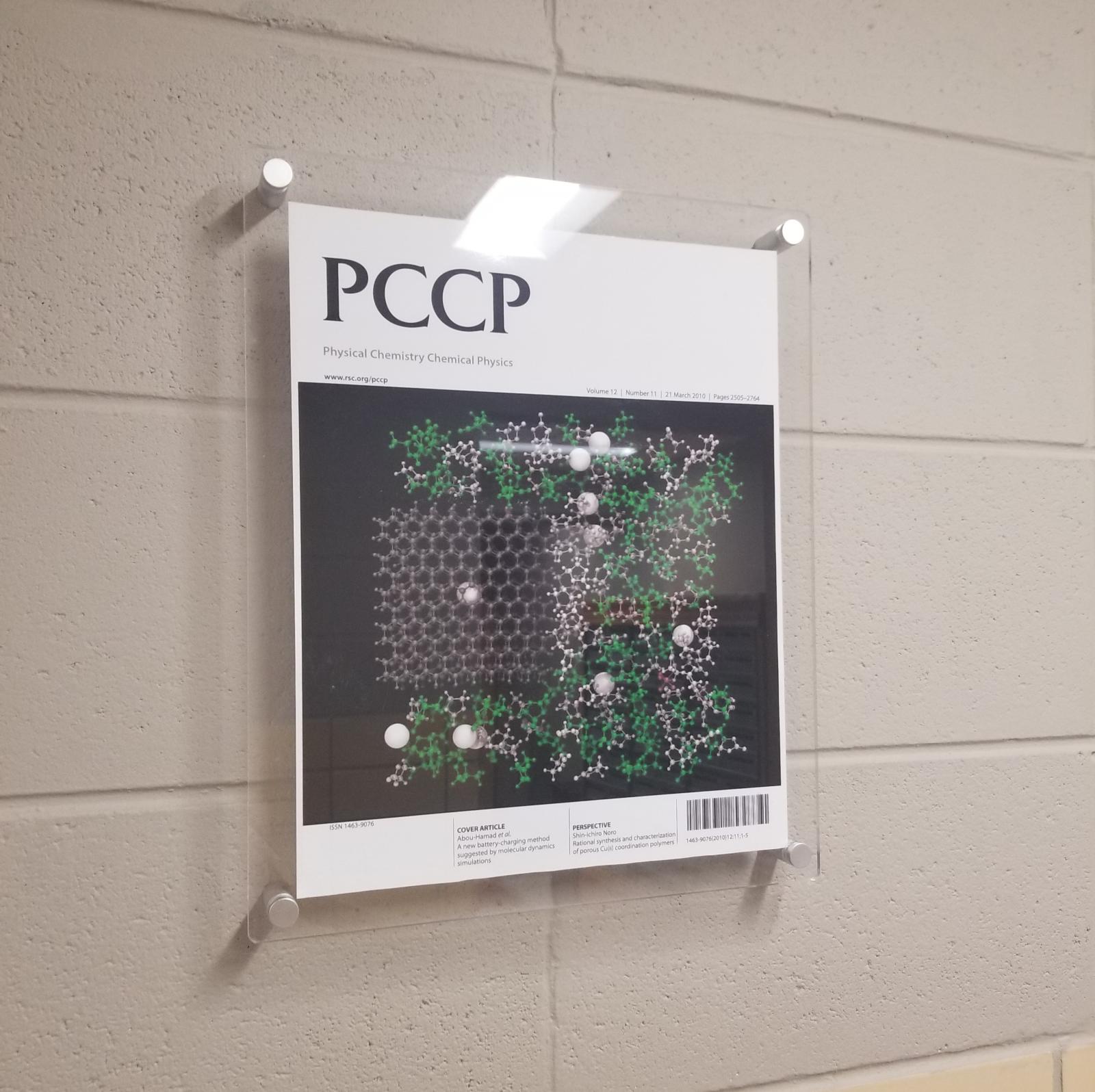 Hung up cover art on the first floor of Hand Lab